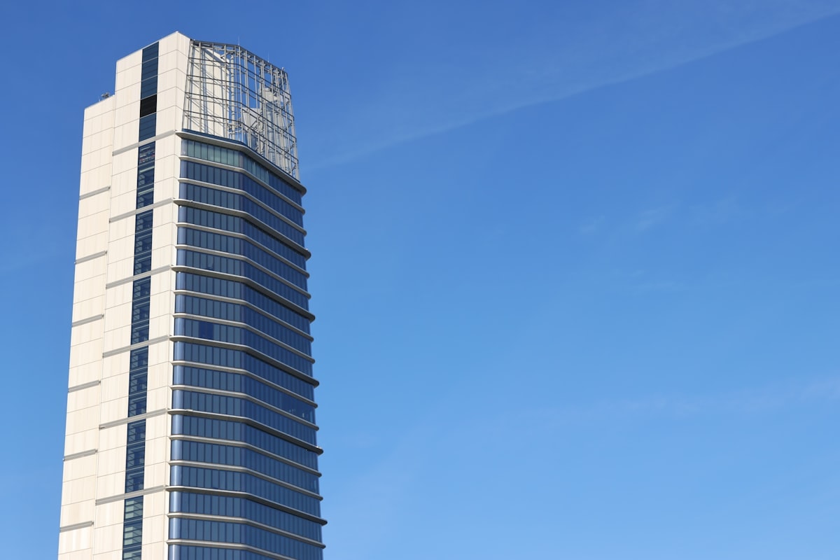 Azure Office tower with blue-tinted glass facade against Amman skyline