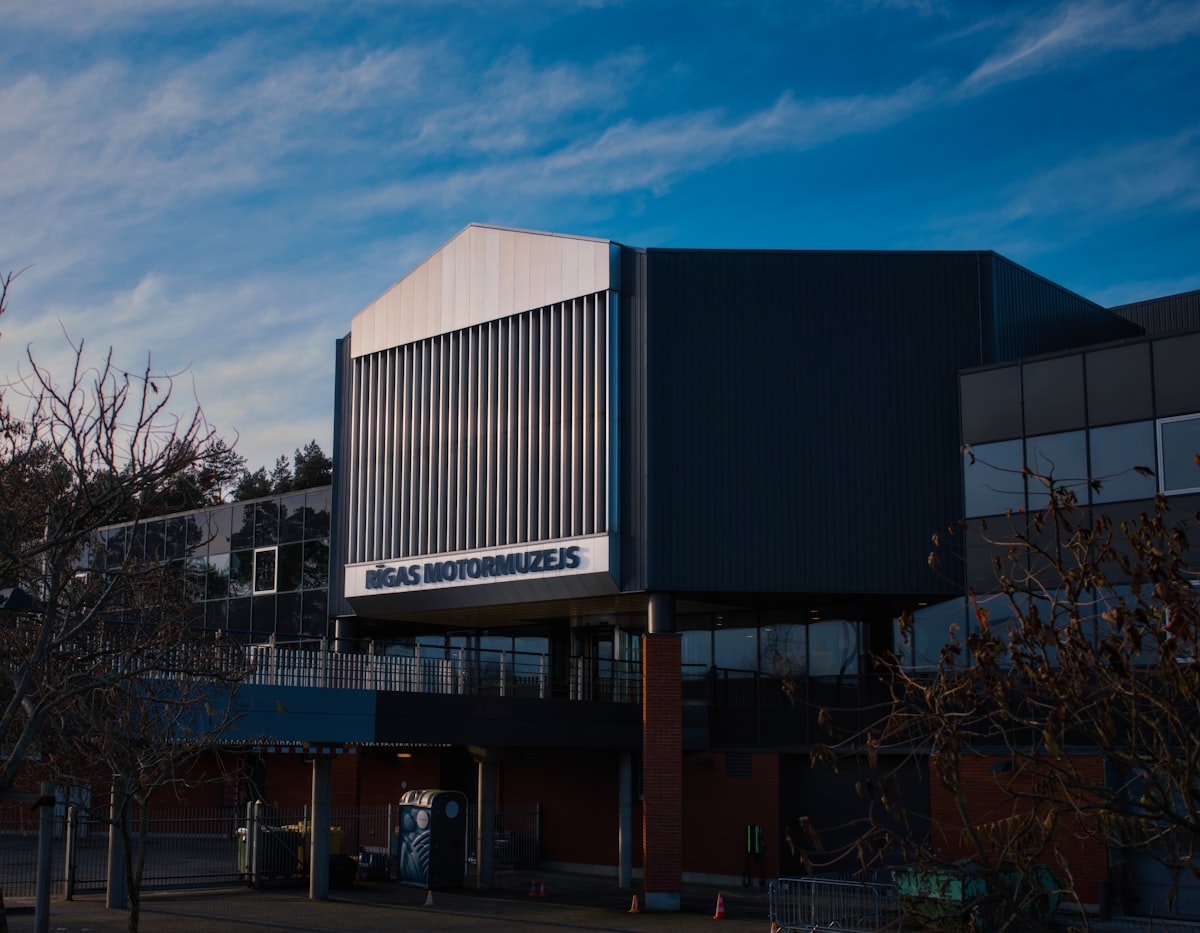 Aerial view of Oasis Pavilion showing undulating roof forms against desert landscape