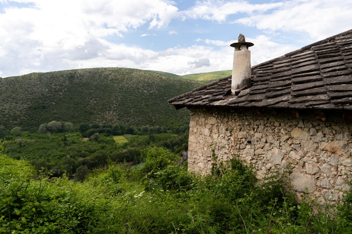 Living room with stone walls and dramatic canyon-framing window