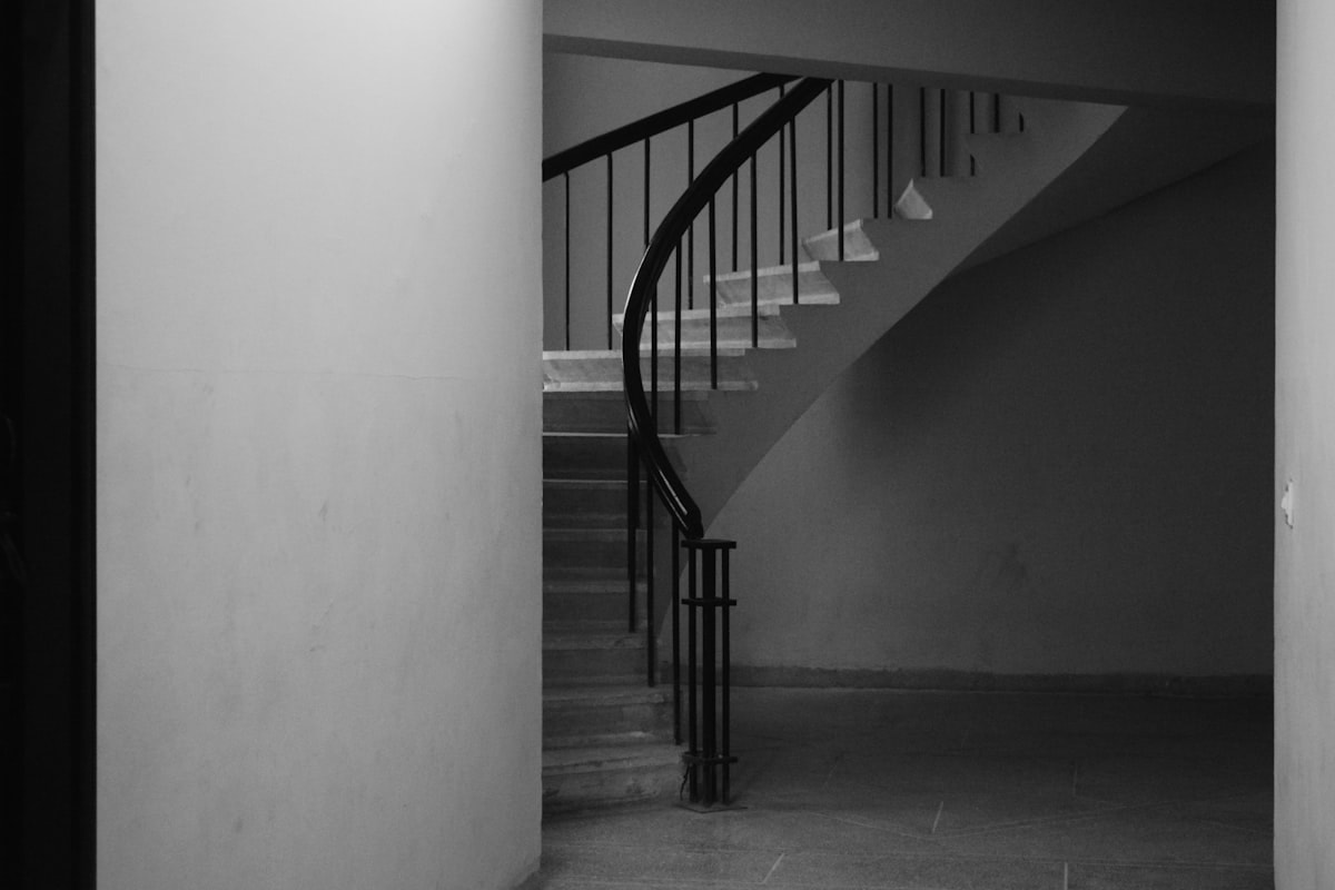Sculptural concrete staircase with natural light from above